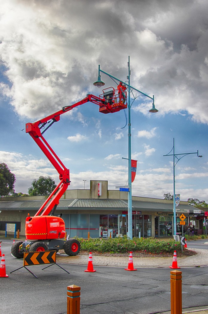 Pole work: Workmen use a cherry picker to install the long awaited CCTV cameras in High St, Hastings. Picture: Cameron McCullough