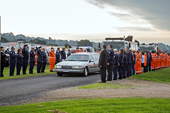 Fitting farewell: Dozens of SES and CFA personnel formed a guard of honour along the Peninsula Aero Club airstrip on 10 June to farewell devoted volunteer Peter Doutch, who died in an ultralight aircraft crash inTyabb.