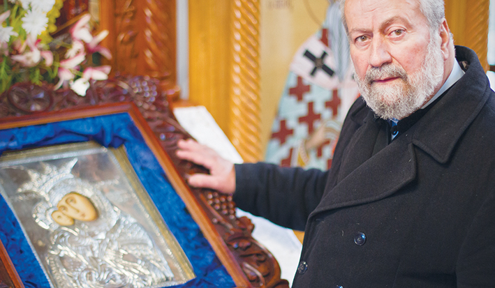 Devastated: The Reverend Father Eleftherios Tatsis with the Virgin Mary icon after the jewellery theft. Picture: Cameron McCullough
