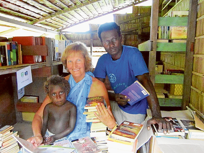 Water on tap: Sue Smith in the Lokuru community library, Rendova Island with Jackson Quavo, of Mile 6, who is helping Sue with the Water is Life project.
