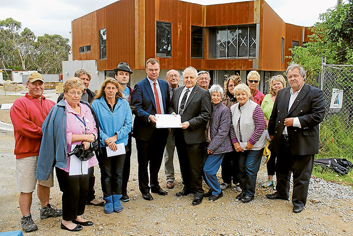 Sign here: Liberal politicians Edward O’Donohue and Neale Burgess, centre, are ready to deliver petitions calling on the state government to hire more police. Photo supplied.