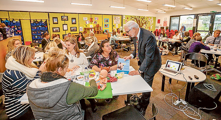 Language priority: Professor Joseph Sparling talks with parents and teachers at Seawinds Community Hub about his educational program being adopted by Eastbourne Primary School. Picture: Yanni
