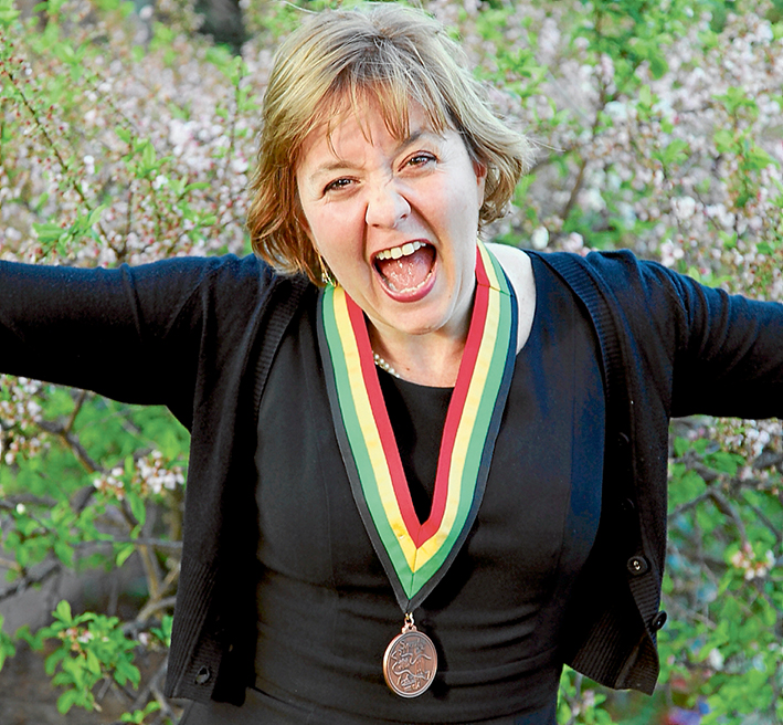 Honoured citizen: Luz Restrepo shows her joy last October after receiving the St Michael’s medallion in recognition for her work in helping prevent violence, trauma and destructiveness or promotes growth, health and wellbeing.