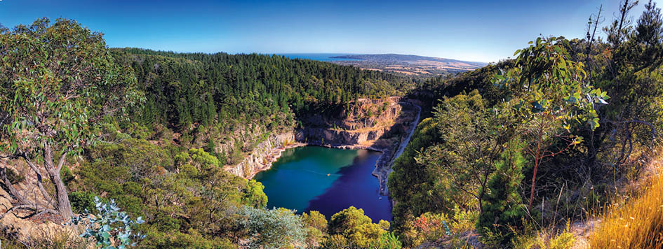 New battle: The disused Pioneer quarry at Dromana on the Arthurs Seat escarpment. It could be used as a waste consolidation station after the Rye landfill closes. The waste would be stored on relatively flat land between the flooded pit and Boundary Rd, which is hidden by trees in this photo. Picture: Yanni