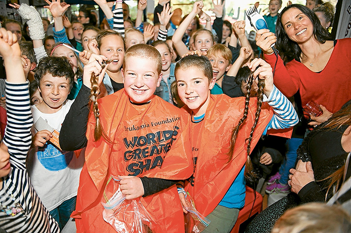 Cuts for a cause: Showing off their new hairstyles are Balnarring girls Chelsea Poll and Grace Chapman, with Grace’s mum Georgia, right, holding up the shears. Picture: Alison Griffiths