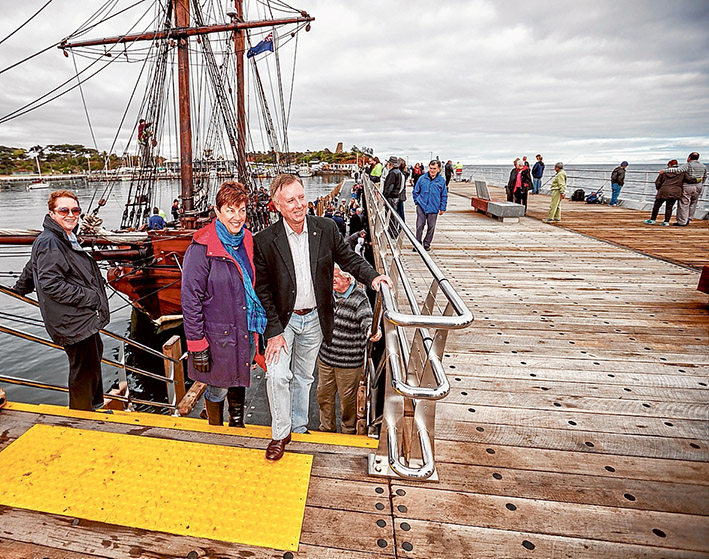 Mission accomplished: Mornington MP David Morris, left, was at the pier with his wife Linda to celebrate the completion of a “bungled” project which was re-started when he was part of the Liberal-Coalition government. Also trying out the new pier are Neil and Linda Sanddington, above, with pugs Ava and Theo. Pictures: Yanni