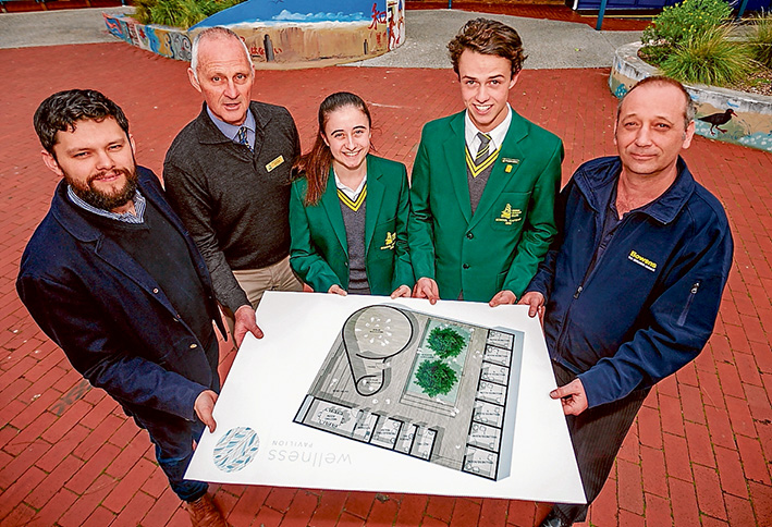 Plans at the ready: Holding plans for the Wellness Pavilion planned for Rosebud Secondary College are, from left, architect Nick Cini, assistant principal Geoff Seletto, school captains Alexandra Dellaportas and CooperCorbett, and George Stolz from Bowens. Picture: Yanni