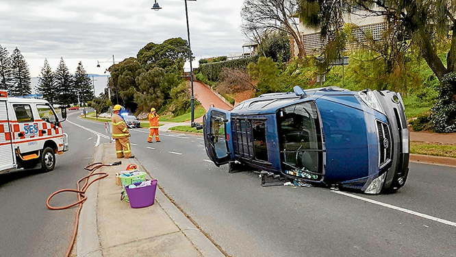 Flip side: Emergency crews freed a driver from this car which ended on its side in Ocean Beach Rd, Sorrento. Picture: David Lammers