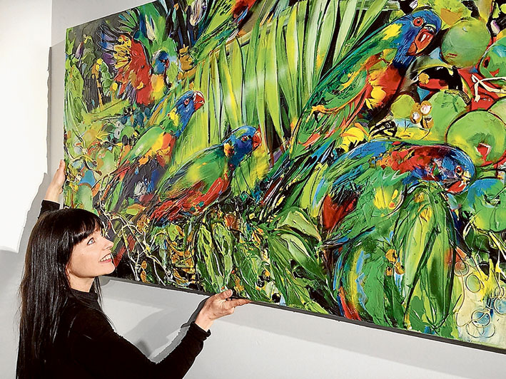 Hanging day: Rebecca Davy hangs a painting by Gail Rutland Gillard at the revamped Noels Gallery, 1175 Mornington-Flinders Rd, Red Hill.