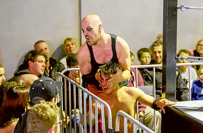 Ringside: Zirous Madic and Cody Swift take their battle to the audience, during the Saturday night live appearance at Rosebud West. Picture: Yanni