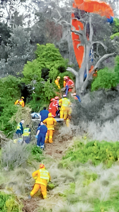 Complex task: Emergency services teams rescue a hang-glider who became tangled in a dead tree on the cliff at Flinders Golf Course on Sunday last week. Picture: Sorrento SES