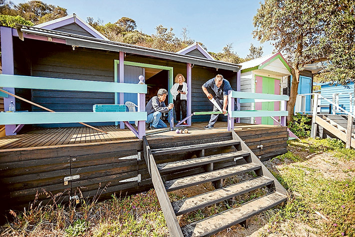 Wilful damage: Mt Martha bathing box owners Derek and Wendy Leong count the cost as carpenter Iain Proudfoot makes repairs. Picture: Yanni