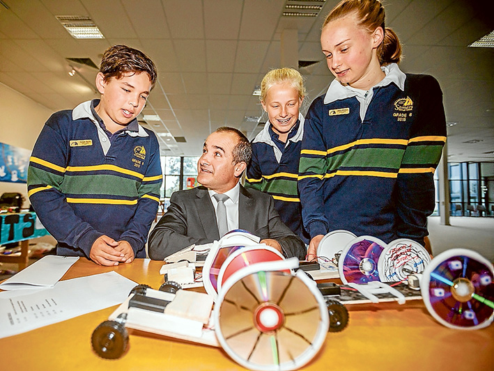 All the fun of the fair: left, Education Minister James Merlino with Somers Primary School pupils Cooper Squire, Zara Belle and Joanna Mikkelson. Right, Brendon, Aaron and Jake from Tyabb Railway Primary School demonstrate their coloured water droplet experiment. Below, Luke, Tara, Pia, Luke and Henry from Balnarring Primary School use entertainment to showcase science. Pictures: Yanni