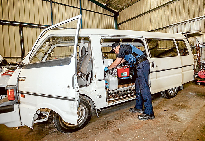 Telltale signs: Somerville Senior Constable Dave Taylor dusts the caravan for fingerprints.