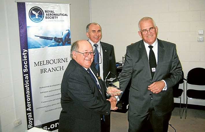 Here’s to you: Peninsula Aero Club president Peter Bernardi accepts the Aero Club of the Year award from Captain David Jacobson watched by Royal Aeronautical Society chairman Murray Stimsom.