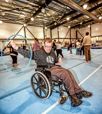 Action for all: Marcus Watson spins the hoola hoop while Connor, of the Nepean School, tries table tennis with help from his carer, Robyn. Pictures: Yanni