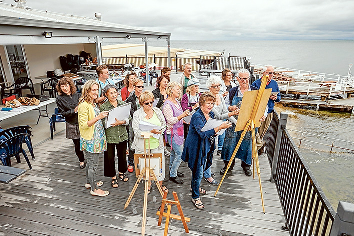 Eye for detail: Instructor Colin Johnson helps artist Pam with her work. Picture: Yanni