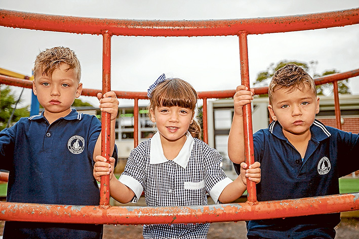 Three times the fun: Triplets Donna, Dimitri and Andreas Watson enjoyed their first day at Mornington Primary School last week. Picture: Yanni