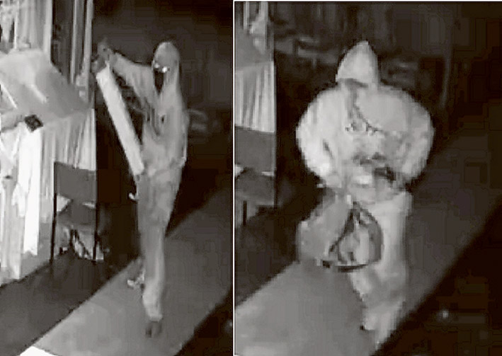 Caught in the act: Two men wearing hoodies or overalls are have been captured on CCTV raiding the Greek Orthodox church, Red Hill.