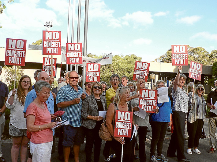 Path protest: Somers residents opposed to concrete footpaths and how they are being financed show their feelings before Mornington Peninsula Shire’s 8 February meeting. Councillors decided to proceed with a special charge scheme.