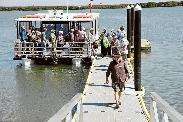 All ashore: Passengers disembark at Tooraddin after a cruise in the north eastern arm of Western Port which went as far as Stockyard Point, below, populated by one fisherman and seabirds waiting for the tide to drop.