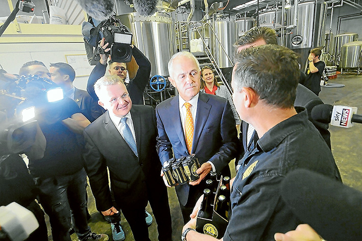 Packing them in: Liberal Dunkley MP Bruce Billson and Prime Minister Malcolm Turnbull followed by TV news crews visit the Mornington Peninsula Brewery. Picture: Jarryd Bravo