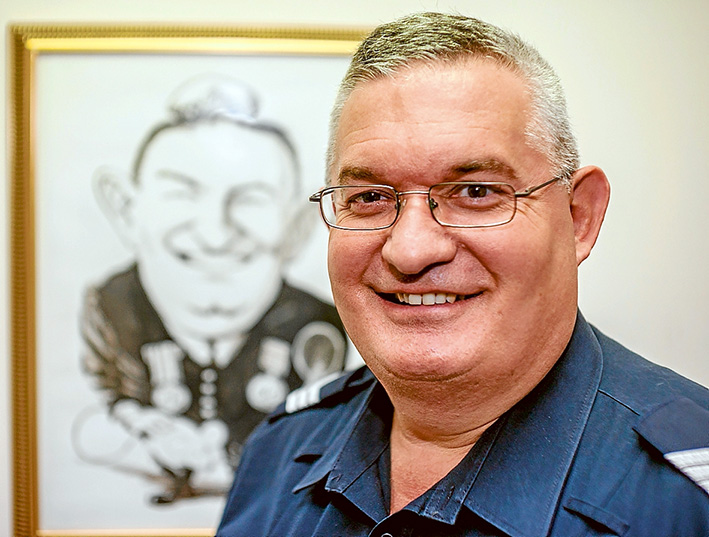 Time on his side: Dromana sergeant Paul Dixon contemplates 35 years in the force and, inset, on his graduation day in 1981. Picture: Yanni