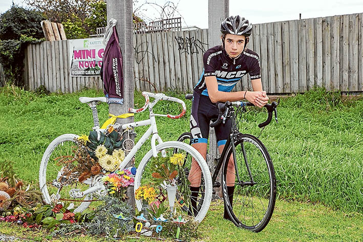 Riding on: Sam Turner, beside the Ghost bike memorial to Joel Hawkins, is determined to live up to his friend’s high standards. Picture: Gary Sissons