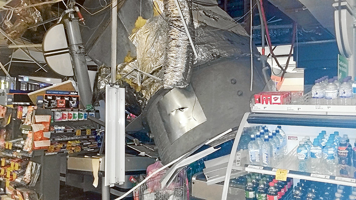 Down and out: The half tonne air conditioner which crashed into the near-empty Woolworths store at Mornington and, below, the blades of the fan which may have caused the collapse. Pictures: Gary Bryant