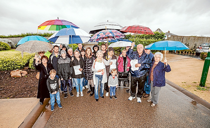 Too many units: Mt Martha residents opposed to a high density housing development brave the elements to show their opposition. Picture: Yanni