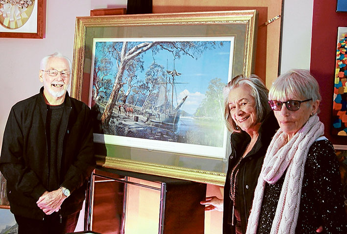 Master marine artist: Richard Linton, pictured with a print of his painting “The Founding of Melbourne”, and The Crib 2018 Arts Studio owner Norma Carew, and studio supporter Shirley Butler. Picture: Cameron McCullough
