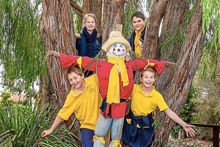 Class act: Artist Michael Leeworthy treated Eastbourne Primary School pupils to a morning of making scarecrows. Here, Jazmyn and Shaun (rear) and Bruce and Sophie show off their creation. Picture: Gary Sissons
