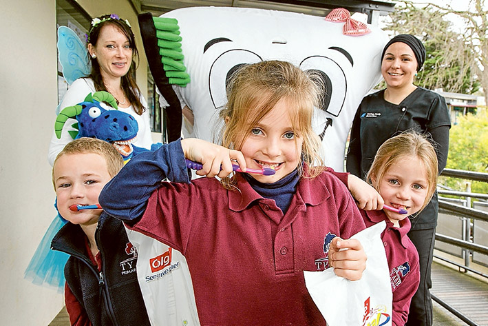 Healthy teeth message: The Tooth Fairy, Lola the Molar and oral health therapist Hafize Coskun; front pupils Max, Evie and Ella. Picture: Gary Sissons