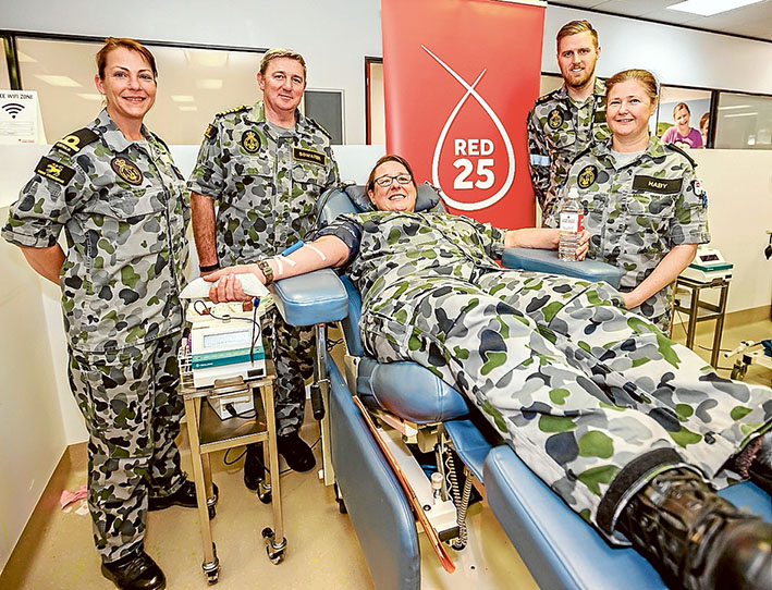 Bleeding by example: Sub Lieutenant Katherine Mulheron, Captain Stephen Bowater, Leading Seaman Jordan Manie and Able Seaman Debbie C Haby support Commander Melanie Verho as she gives blood. Picture: Yanni