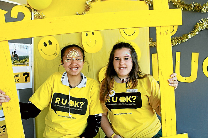 In the frame: Riley Ellis and Skye de Jarlis use the photo booth to help strengthen the message of community connection and how to be a good friend.