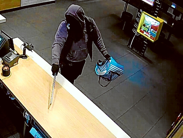 Armed robberies: CCTV images of one of two men police are seeking.