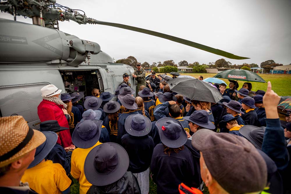 Inspiring message: Eastbourne Primary pupils flock to the helicopter from HMAS Cerberus. Pictures: Yanni