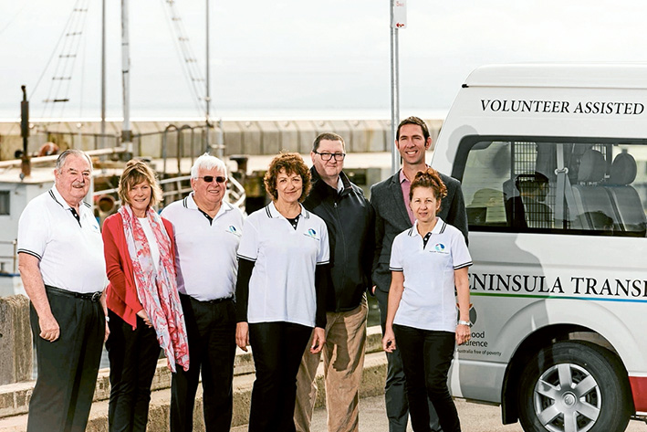 All aboard: Peninsula Transport Assist members Neil Toyne, Sue Worlley, David Calder, Clare Harwood, Andrew Morse, Michael Hillier and Rita Kontos celebrate their win.