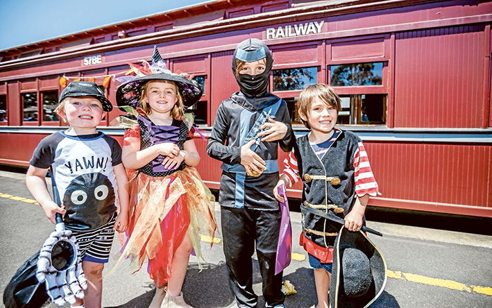 All aboard: On the platform ready to board the Halloween train are, from left, Tommy O’Donohue, Claudia O’Donahue, Oscar and Felix Portelli. Standing in the carriage doorway, below, are Kaylee Ainsworth, Grace and Lucas Allen and Will Milnes. Pictures: Yanni